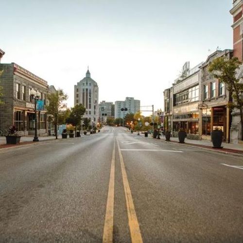 point of view on the double center line of a city street with buildings on both sides, disappearing into the horizon