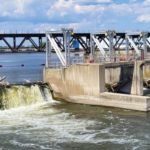 Dam spanning Rock River on sunny day