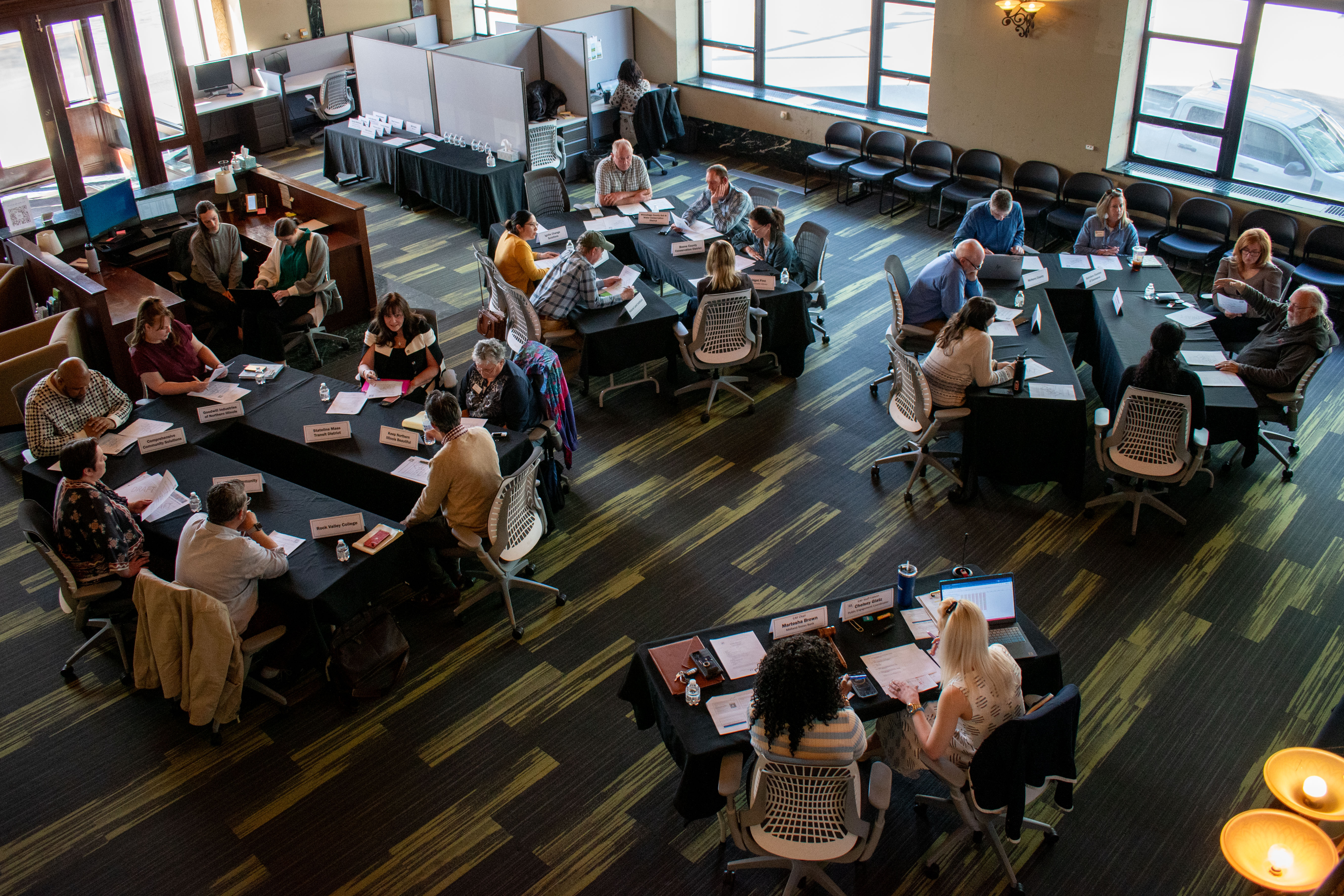 Overhead view of CAF members at tables discussing.