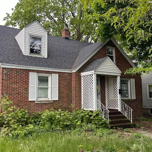 two-story brick house with white trim and white entrance