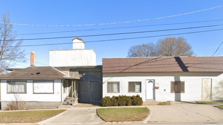 two one-story houses with short driveways connecting to road